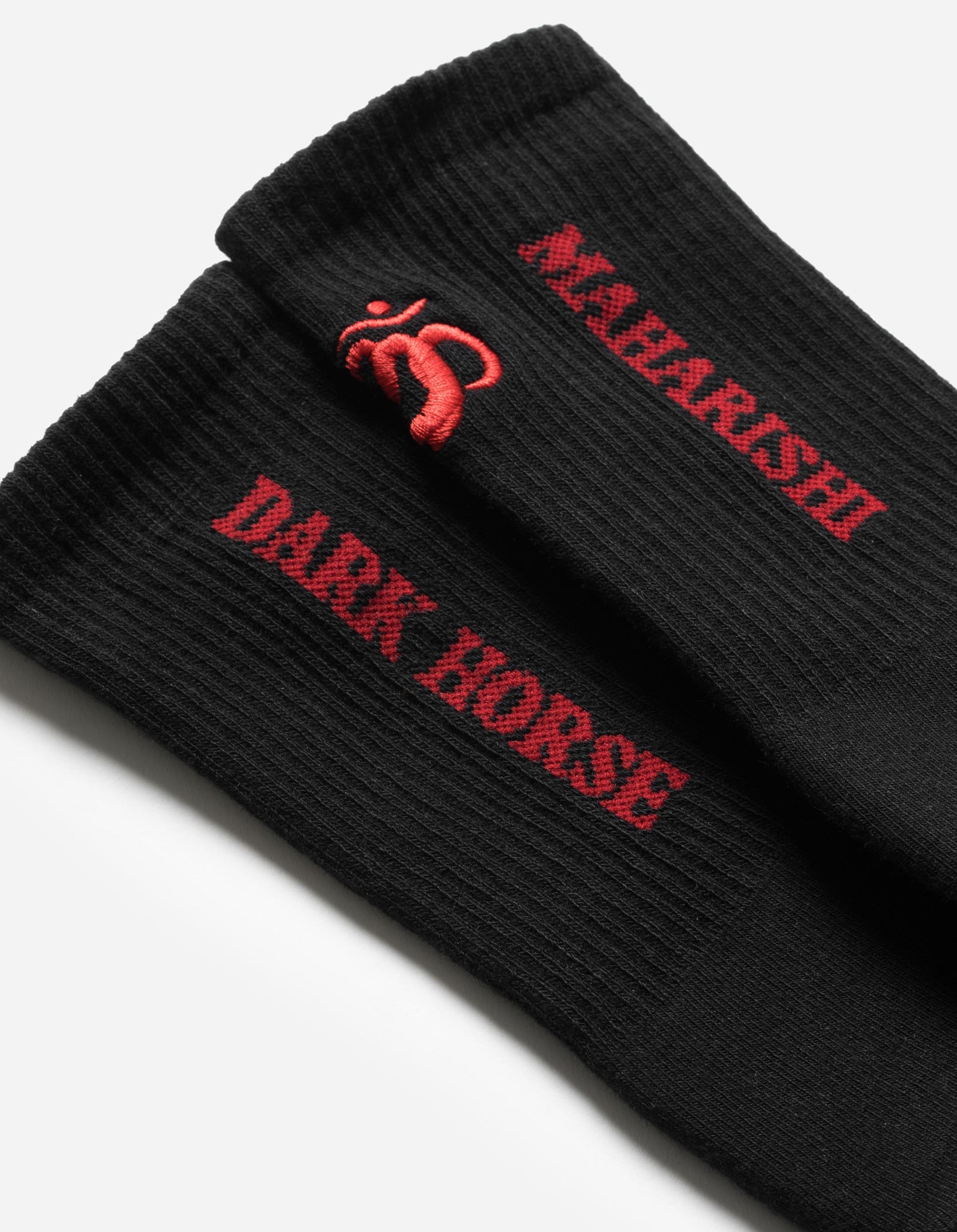 Black socks with red text and logo on a light gray background