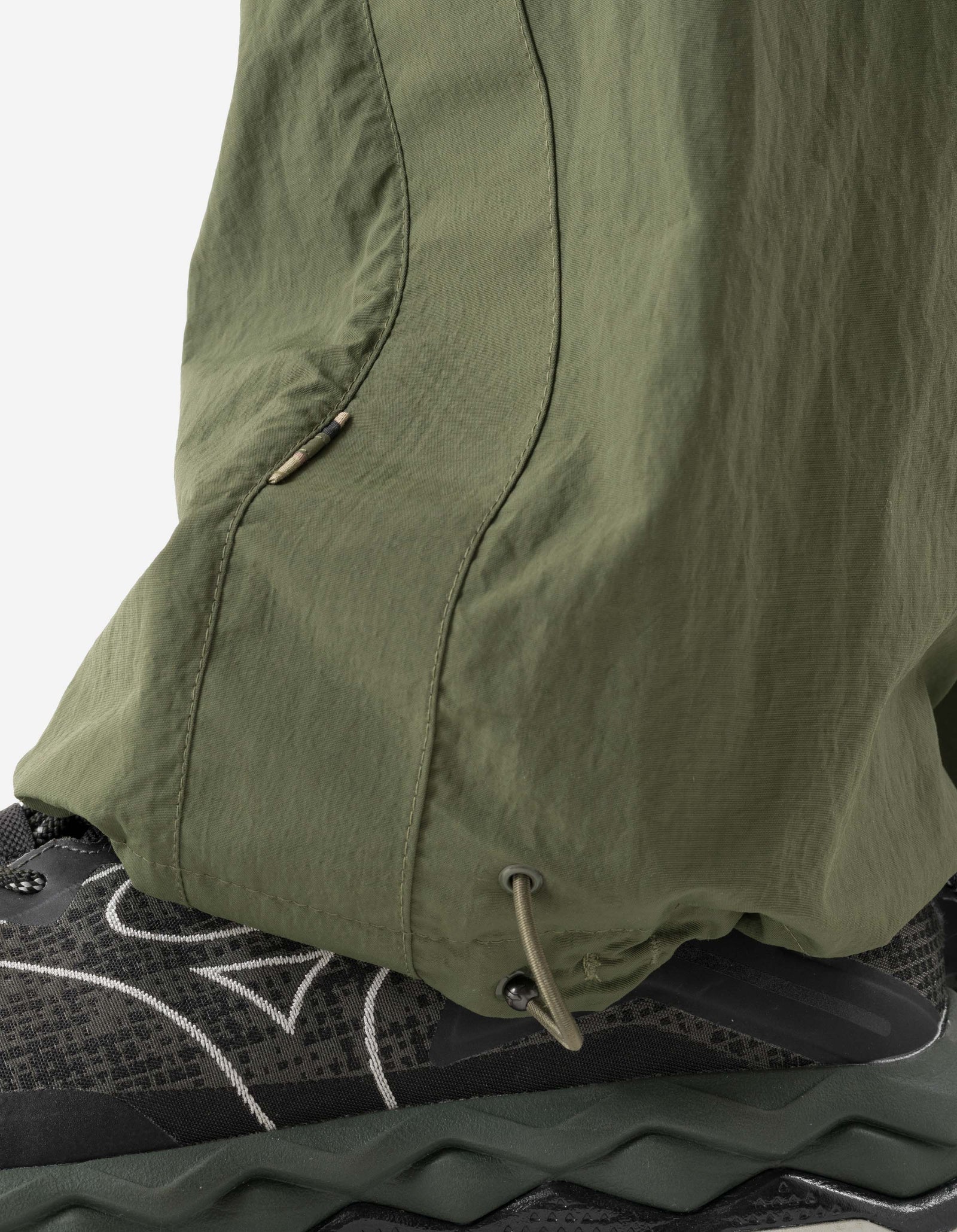Close-up of green pants with a white background