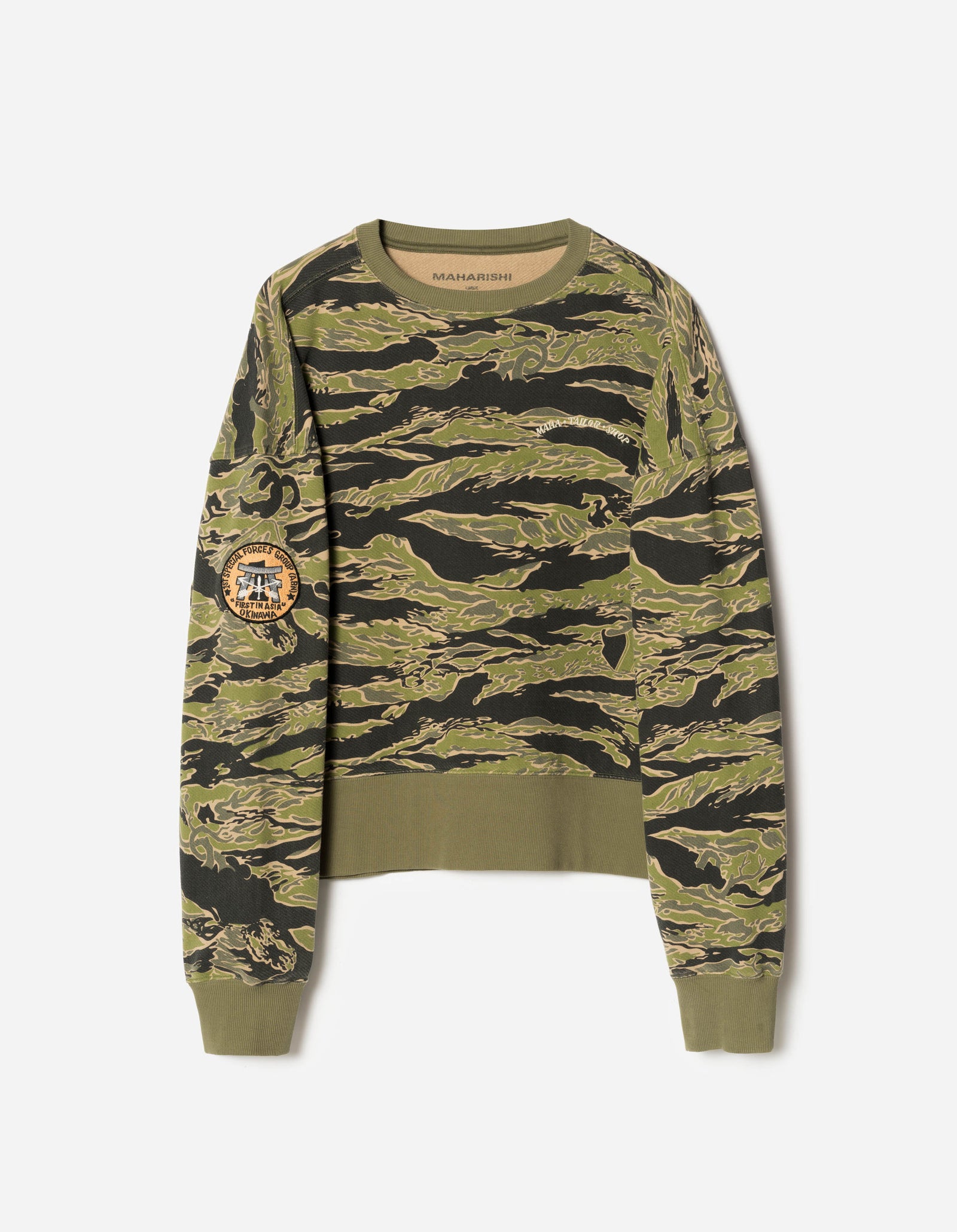 Camouflage-patterned sweater on a white background